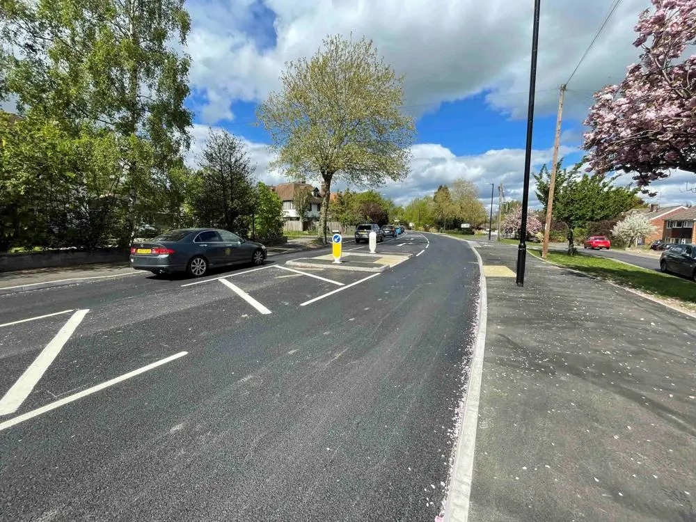 A car on a road with fresh line markings.