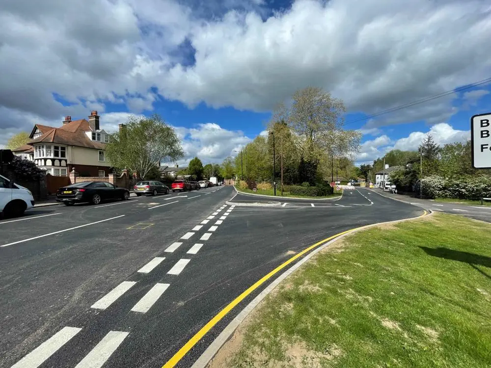 A road junction with markings and grass verge