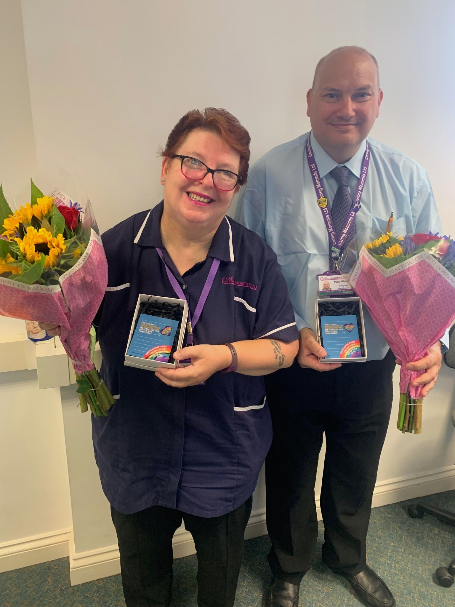 Sally Mills and Paul Watts with flowers and 'Suffolk Says Thanks’ badges.