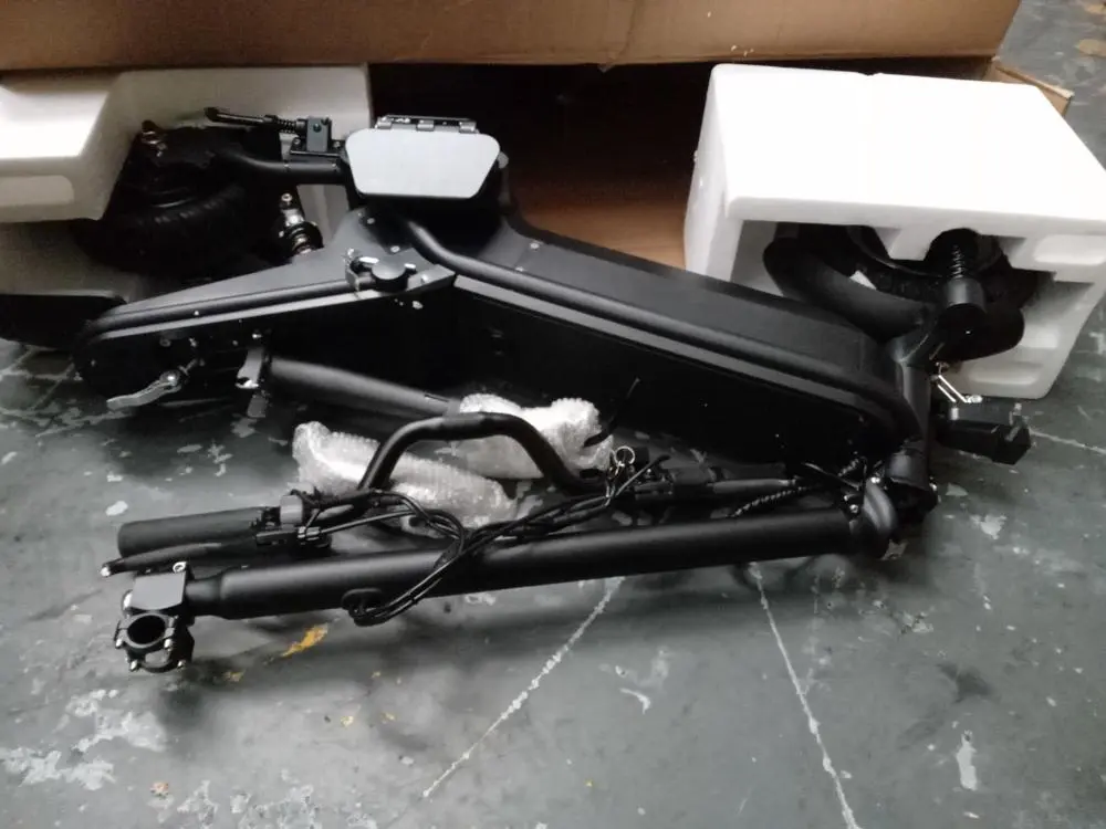 A photo of a black e-scooter out of a box, lying on the floor which has been detained by Suffolk Trading Standards