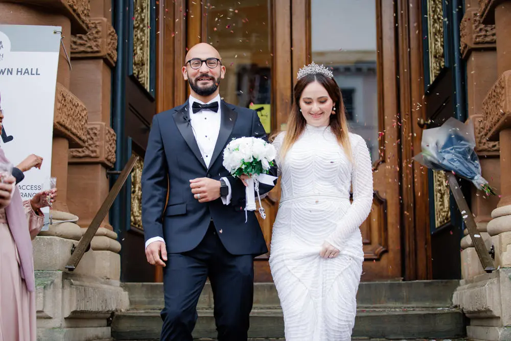 Wedding couple smiling outside Ipswich Town Hall